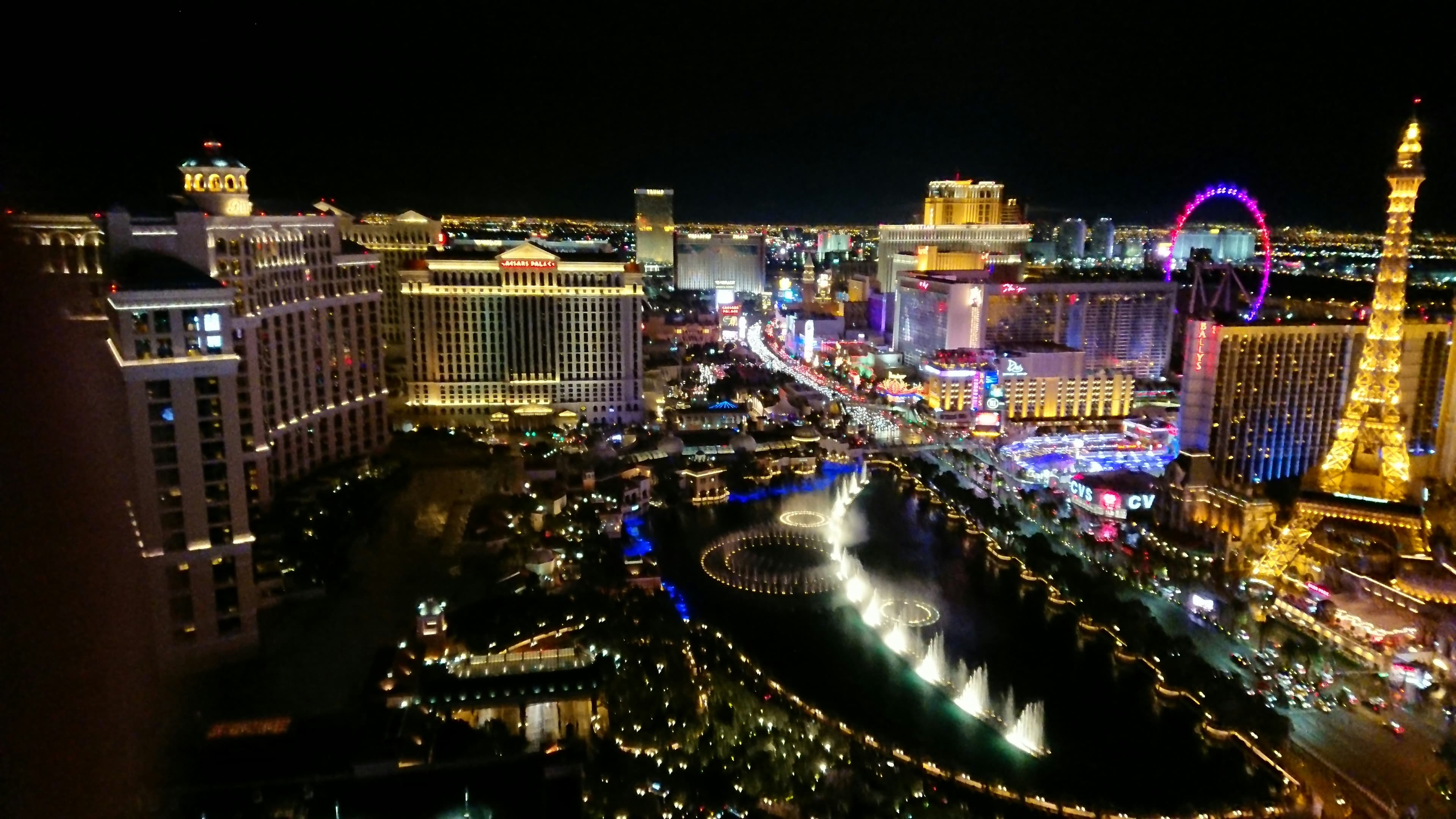 Aerial view of the Las Vegas Strip at night showing luxury vehicles and vibrant nightlife scene