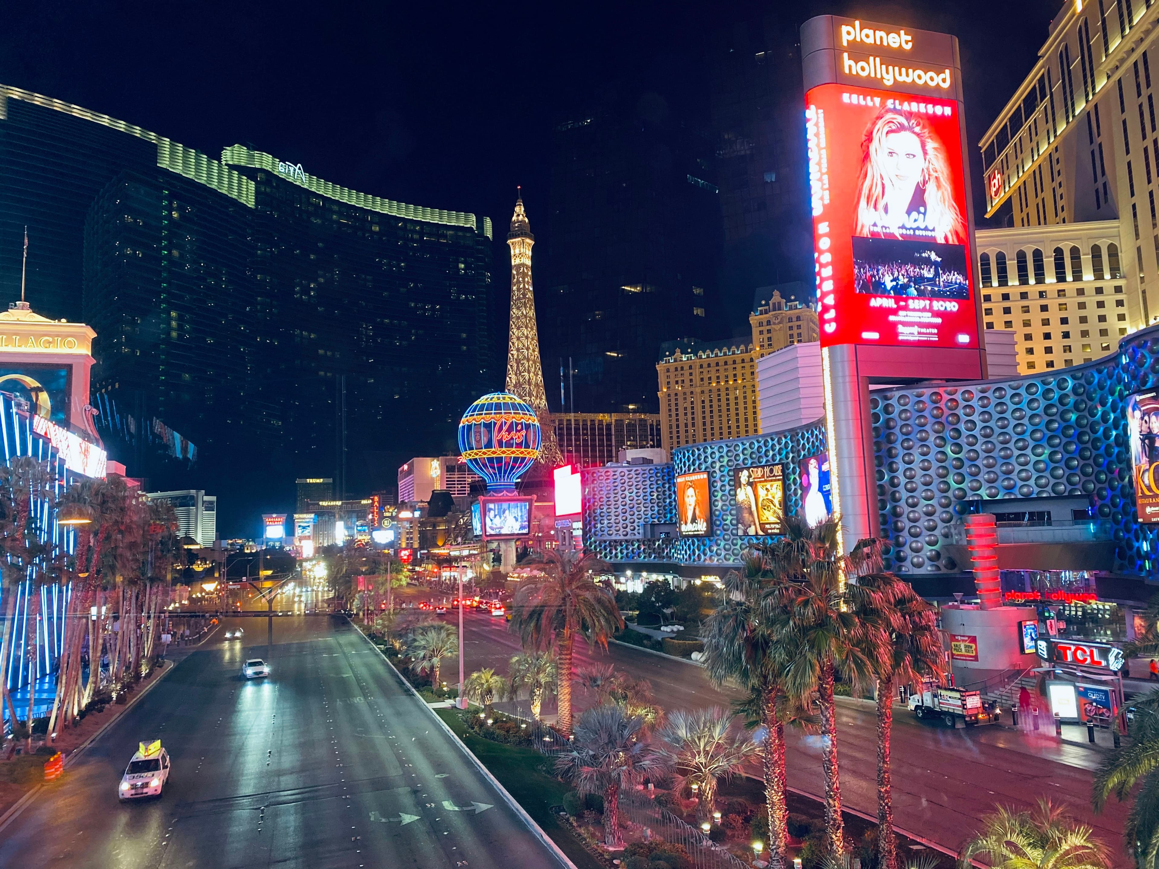 Private luxury SUV touring the Las Vegas Strip at night with iconic casino lights in the background