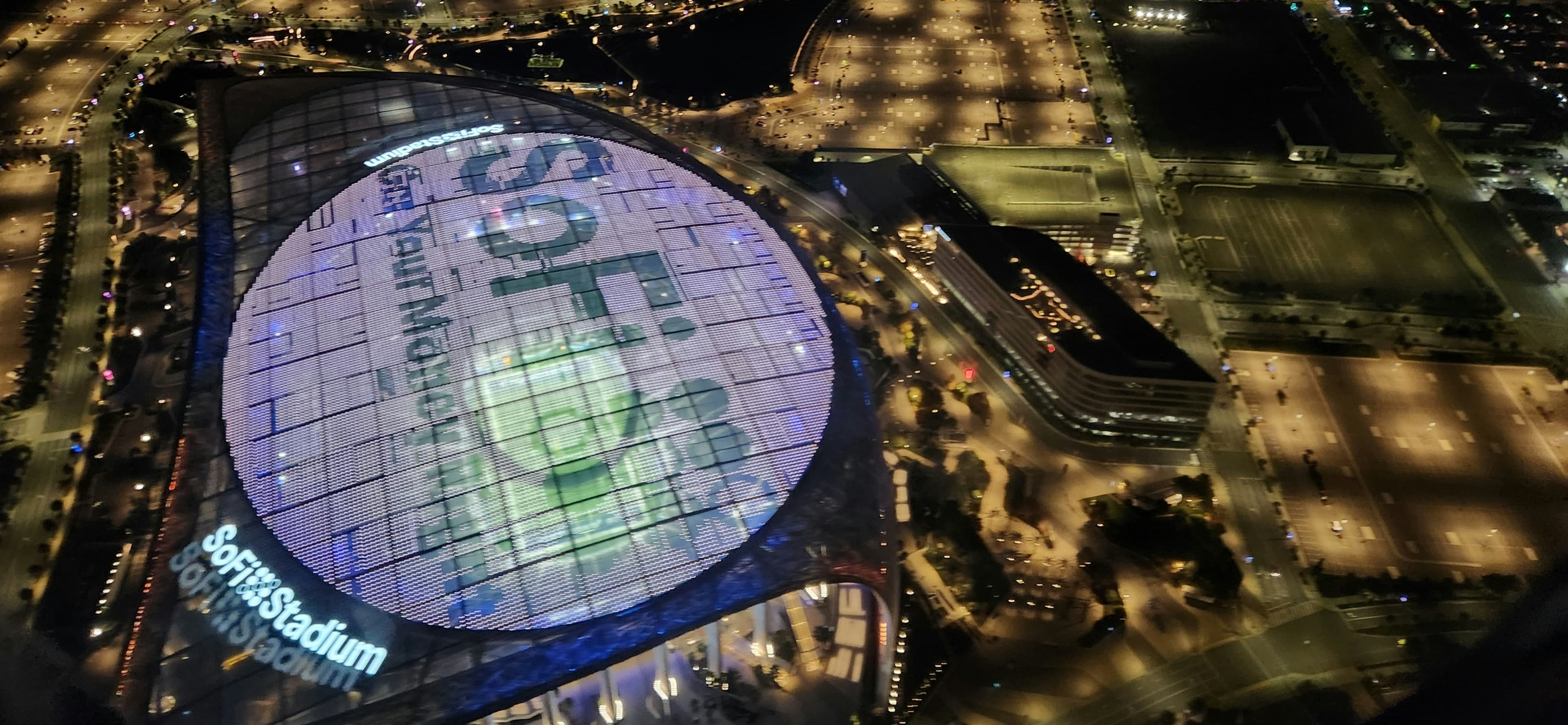 SoFi Stadium in Los Angeles lit up at night during a major international soccer match